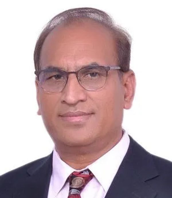 Professional portrait of a middle-aged man in glasses and suit.
