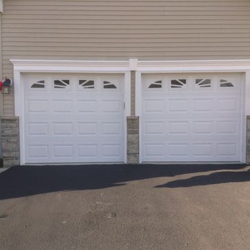 Raised panel garage door with sunburst windows