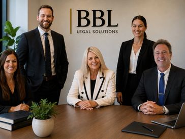 Professional legal team posing in a modern office.