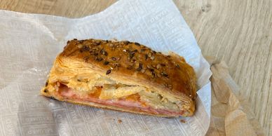 A half-eaten pastry sandwich on Baluard Barcelona wrapping.