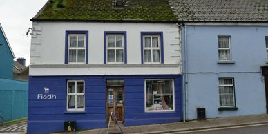 Fiadh Design.Blue and white shopfront on Main Street.Lovely window display of  hand woven accessorie