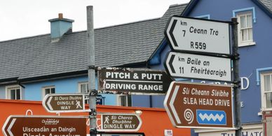 Group of road signs on street for Dingle Way,Pitch and Putt,Slea Head Drive,Aquarium, Ceann Trá, etc