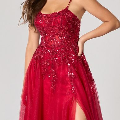 Red sparkling evening dress with slit and spaghetti straps.