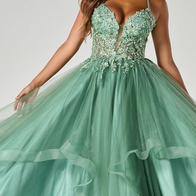 Green embellished evening gown with flowing tulle skirt.