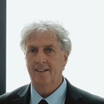Portrait of an older man in a suit.