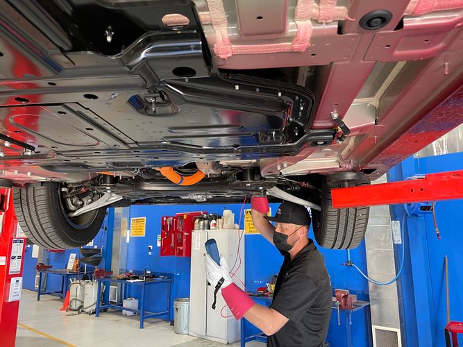 Man diagnosing and servicing an electric vehicle