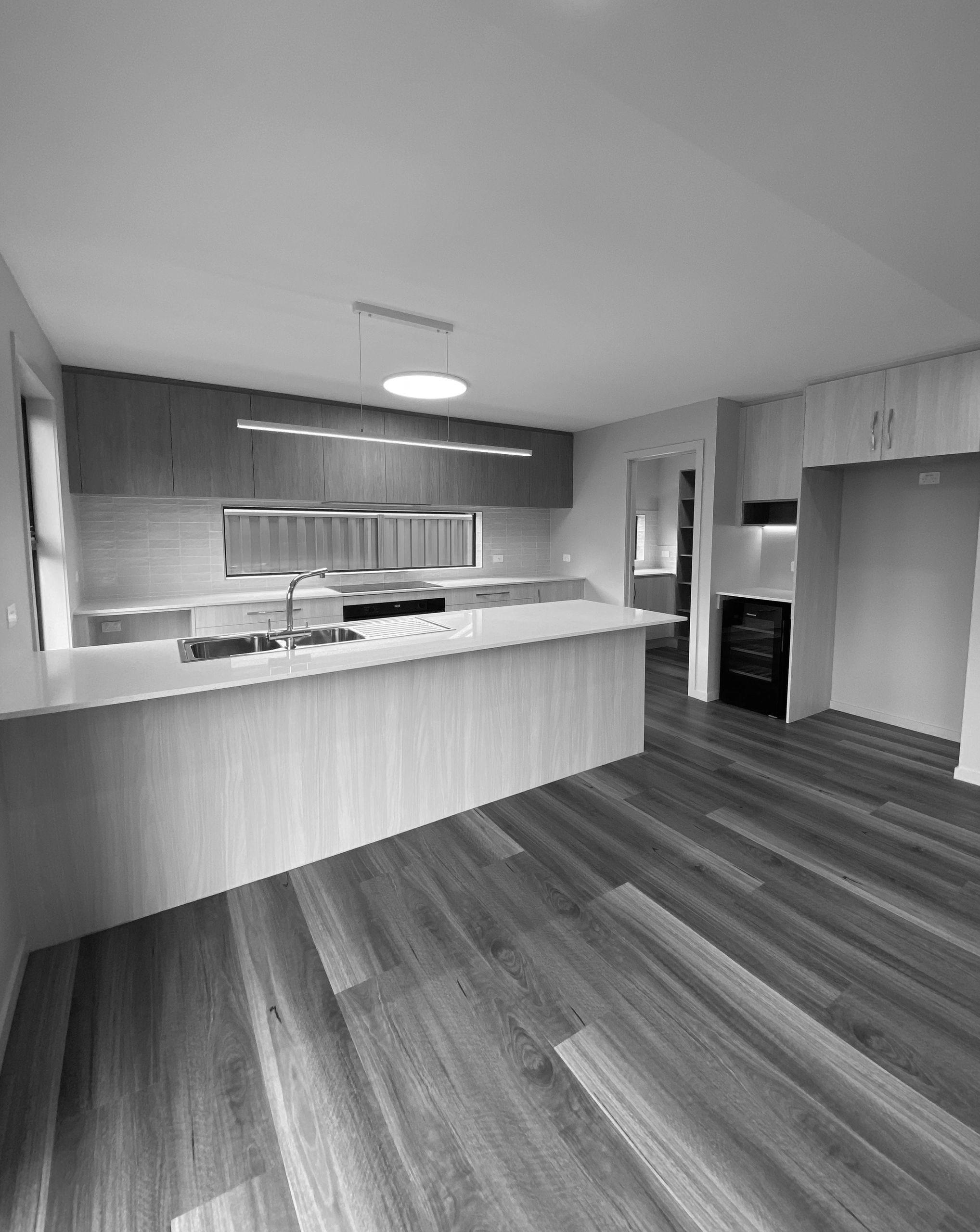 Modern kitchen with wood cabinets and island.