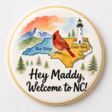 Decorative cookie welcoming Maddy to North Carolina with state landmarks and cardinal.