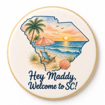 A cookie with a beach scene inside South Carolina outline and welcome message.