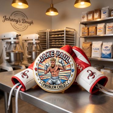 Boxing gloves and a Jake Paul-themed badge on a kitchen counter in a bakery.