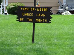Sign for Choice Lawn of the Month in a green lawn.