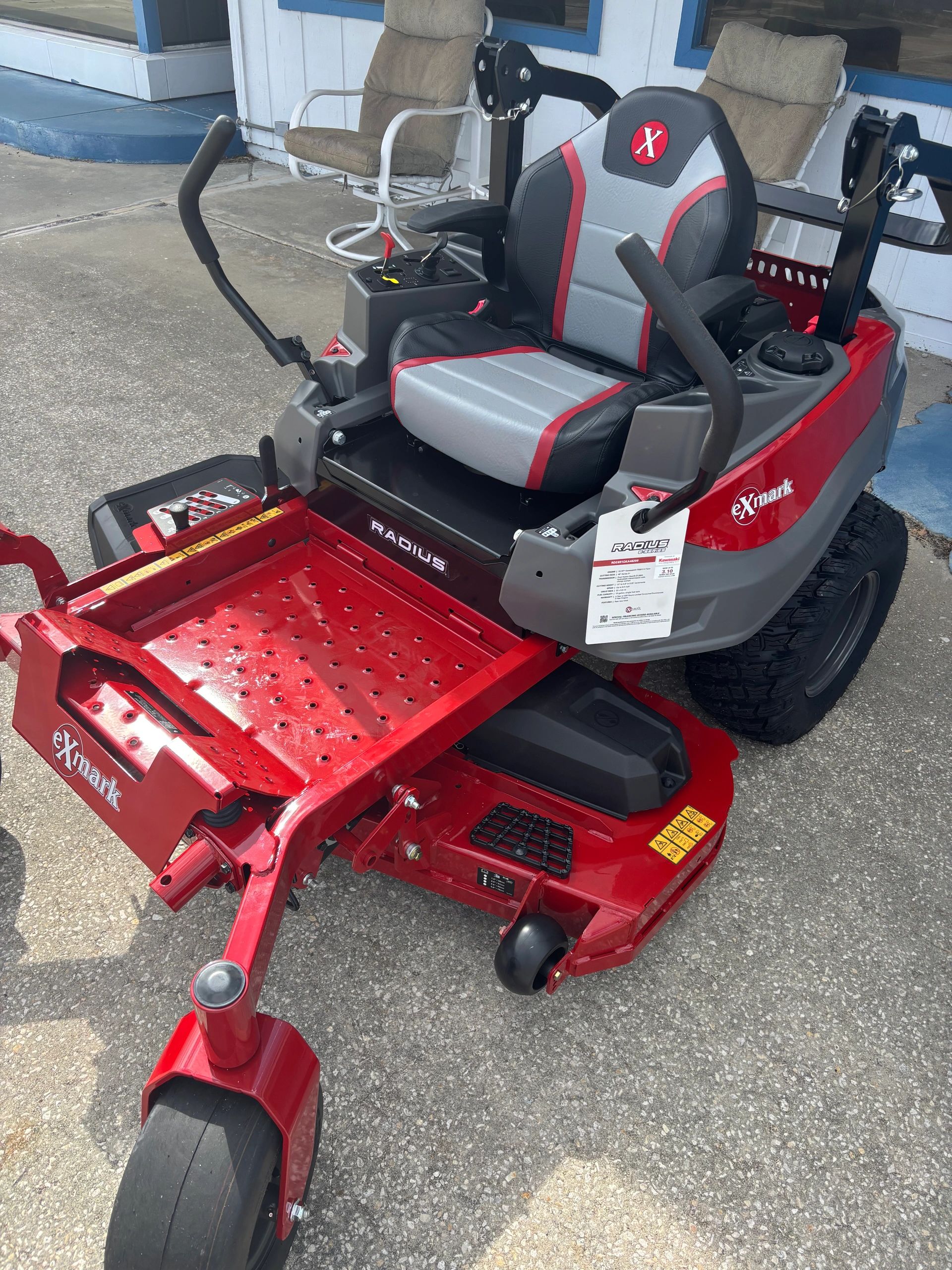Red and gray Exmark Radius zero-turn lawn mower with comfortable seat.