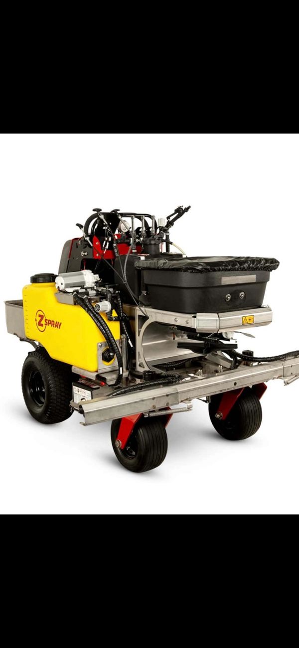 A compact yellow and black agricultural sprayer machine with wheels and multiple hoses.