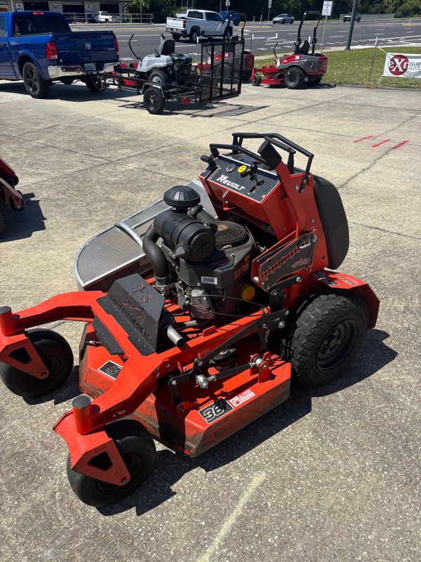 Red Exmark Revolt zero-turn lawn mower parked on concrete.