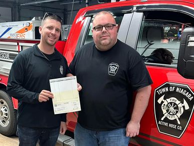 Legislator McKimmie presents a check to Fire Company President Josh Lengen.