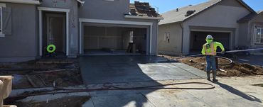 Employee finishing a concrete driveway.