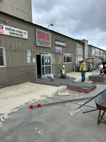 Men installing pavers.