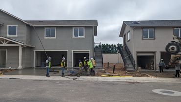 Men Finishing a concrete driveway.