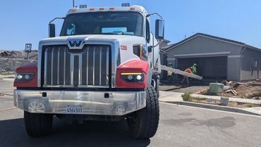 Concrete truck pouring a driveway.