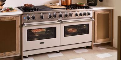 A large double oven with food cooking inside and on top in a modern kitchen.
