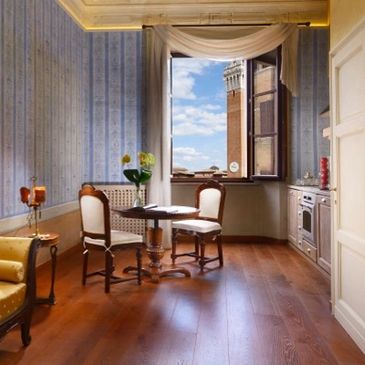 Cozy vintage dining nook with wooden chairs and open window.