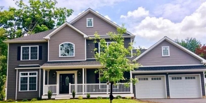 Two-story house with double garage and front porch.