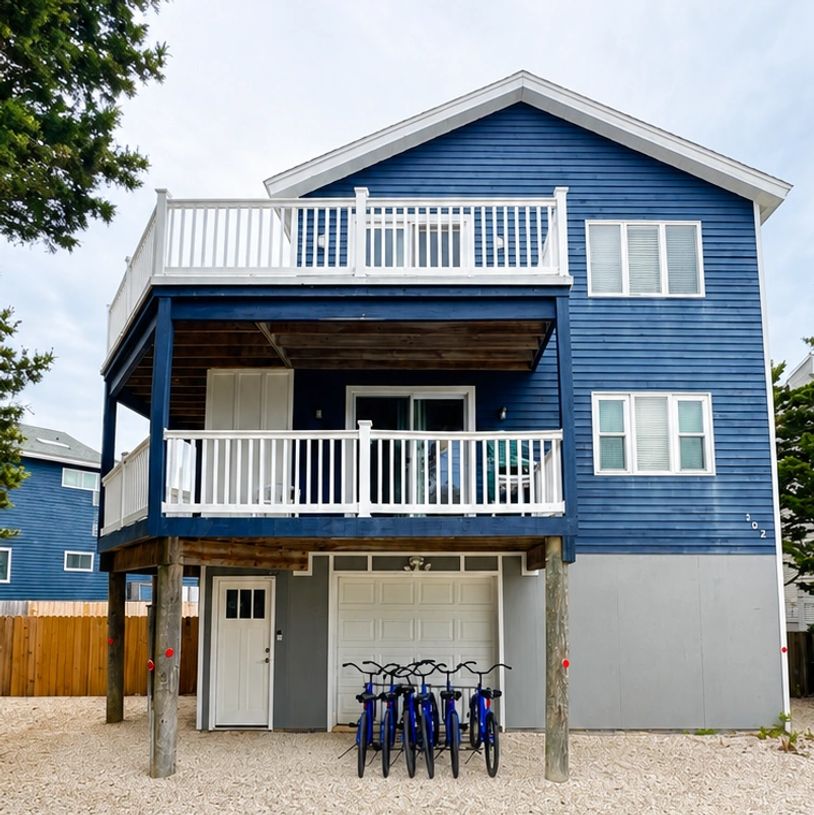Blue two-story house with bikes parked in front.