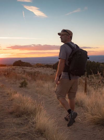 Man hiking an Arizona desert trail at sunset, showing healing and resilience through EMDR therapy.
