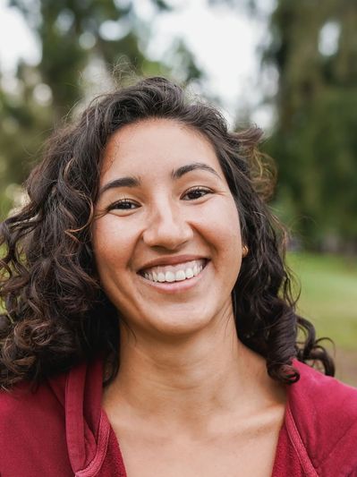 Smiling woman in an Arizona park, showing confidence, joy, and growth through self-esteem therapy.
