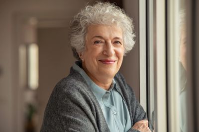 Older woman smiling in Florida, representing hope and healing after grief and loss counseling