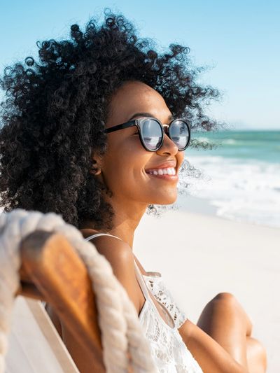 Woman relaxing on Florida beach, showing peace, strength and renewal through virtual trauma therapy.