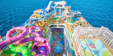 Aerial view of a cruise ship's colorful water park and sports court at sea.