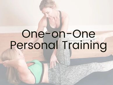 Personal trainer assisting a woman in workout.