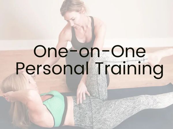 Personal trainer assisting a woman in workout.