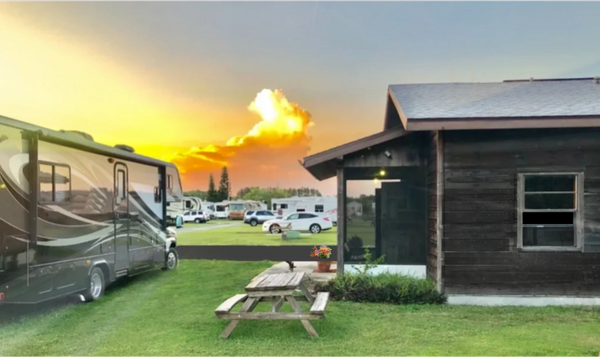 A RV grass site at sunset