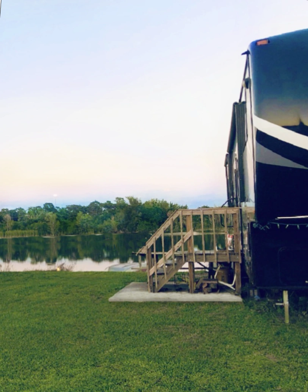 RV Parked with a lakeside view during sunset