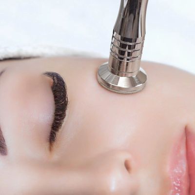 Esthetician performing mcrodermabrasion at Glow & Contour Medspa. A smoother, brighter complexion