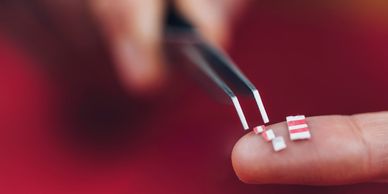 Tiny circuit components on a fingertip.