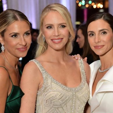 Three exceptionally beautiful single women, each elegantly attired in a stunning dress, 