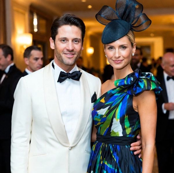  man wearing a tuxedo and a woman elegantly dressed in a beautiful gown.