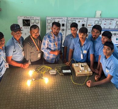 A group of men demonstrating an electrical circuit with light bulbs.