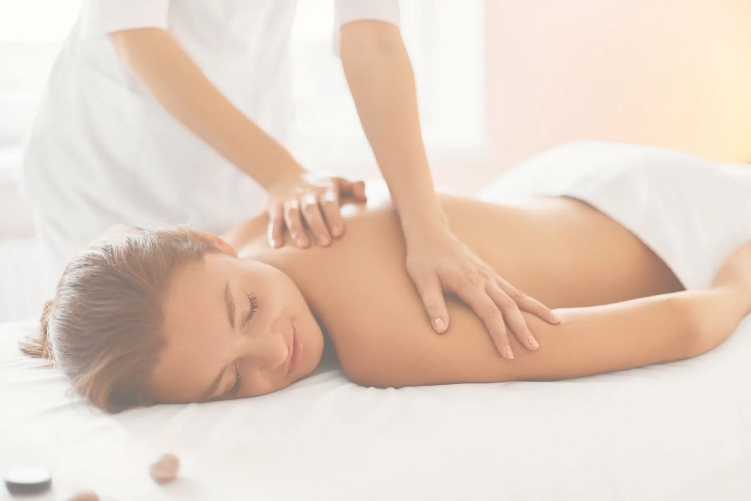 A person enjoys a relaxing back massage in a serene setting.