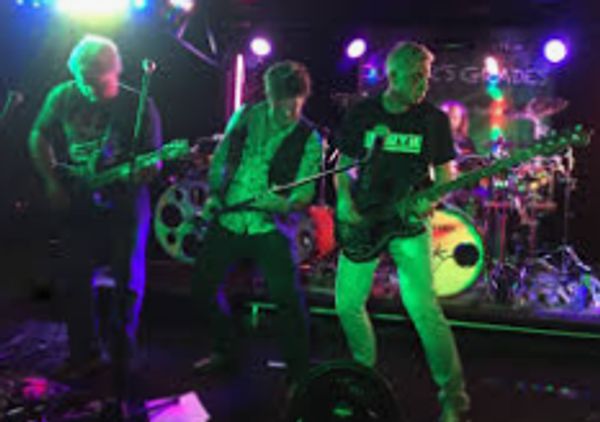 A lively band performing on stage with colorful lighting.