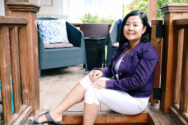 Yollanda Zhang sitting on her porch