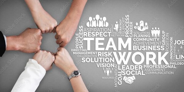 Four hands fist bump symbolizing teamwork and collaboration.