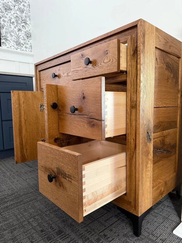 custom built, stained wood vanity with drawers and black nobs