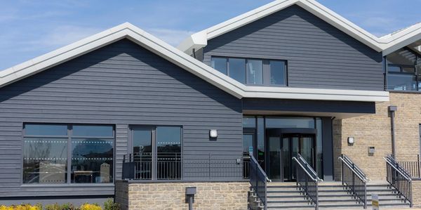 Modern building with gray siding and stone facade.