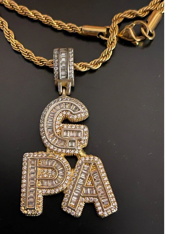 This is g-Pa's gold plated (tarnished)necklace. It spells "G-P-A" and has fake embellishments.