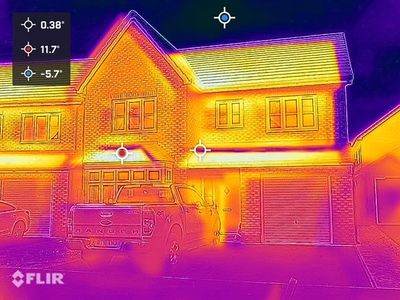 Thermal image of a residential building showing where heat escapes from