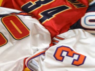 Close-up of colorful basketball jerseys with numbers 34, 00, and 3 visible.